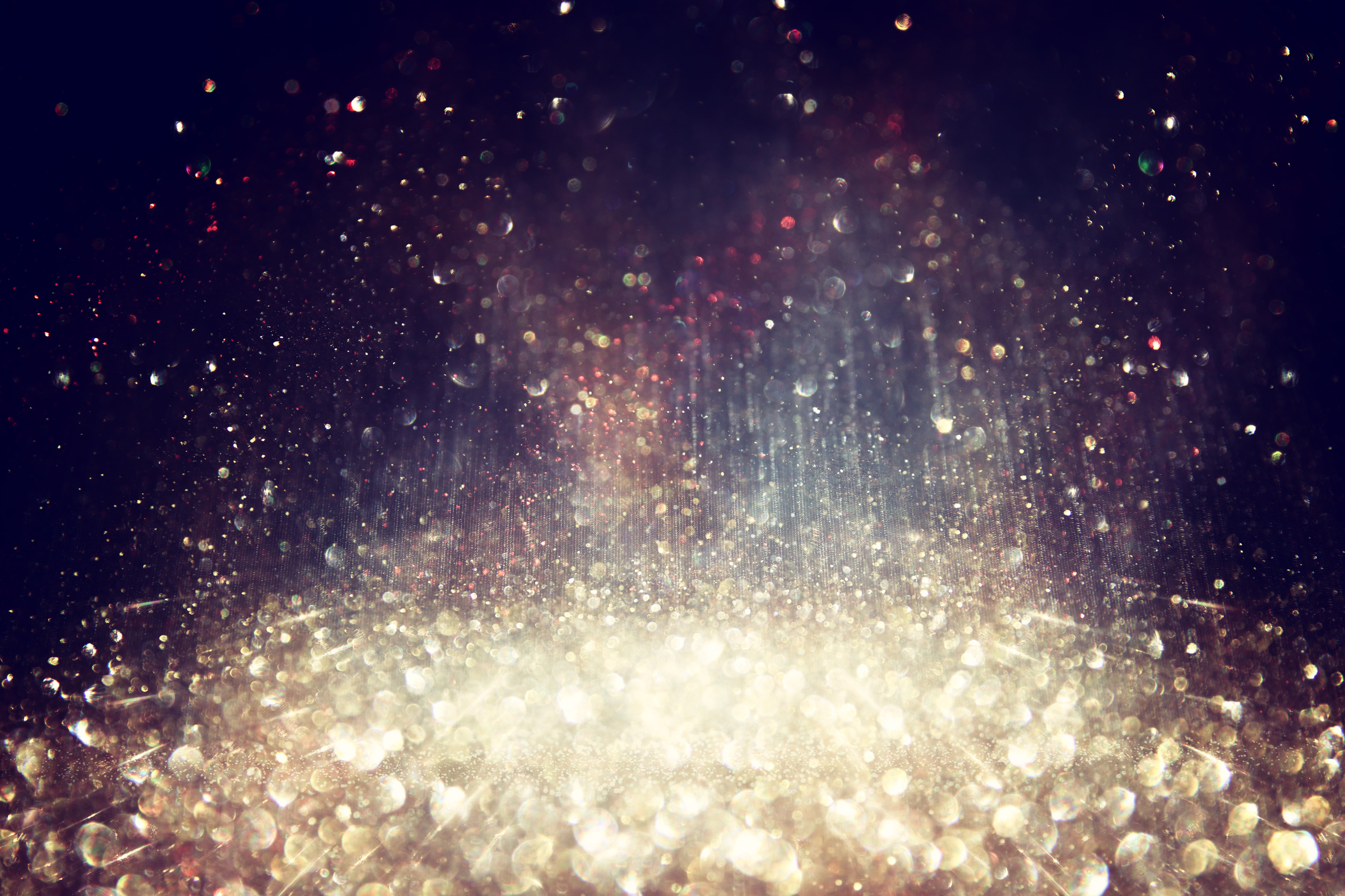 background of abstract glitter lights. silver, gold and black. de focused