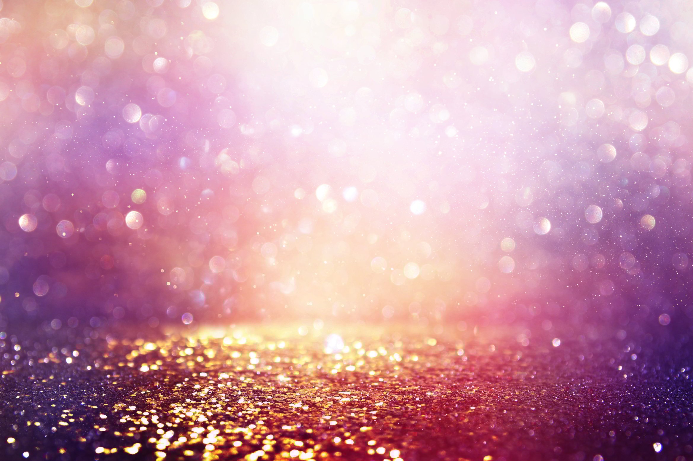 abstract glitter pink, purple and gold lights background. de-focused